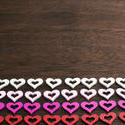 13105   Four lines of colorfully shaped hearts over wood