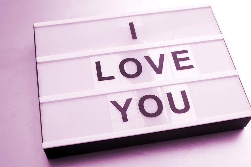 Lightbox with changeable white sign box with black letters I LOVE YOU message, close-up image with pink color effect