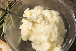13019   Buttered mashed potatoes in glass bowl with spoon