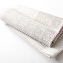 12735   Folded newspapers over neutral color background