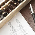 12720   Abacus with balance sheets and pen