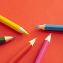 stock image 12183   Randomly placed colored pencils on red