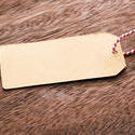 13130   Blank brown gift tag or label on wood