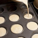 13025   Cake batter being poured into muffin tin