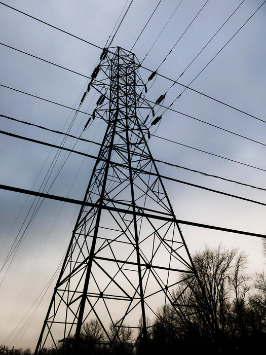 <p>Power line tower with lines cris-crossing in the air.&nbsp;</p>
