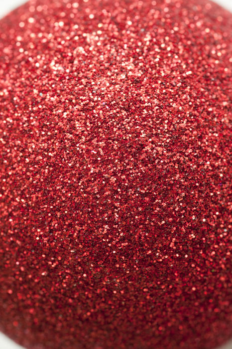 Extreme close up view on red glitter ornament ball