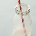 13029   Small empty milk bottle with straw