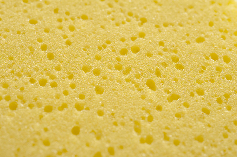 Close up of soft yellow porous sponge with shadowed pock marks