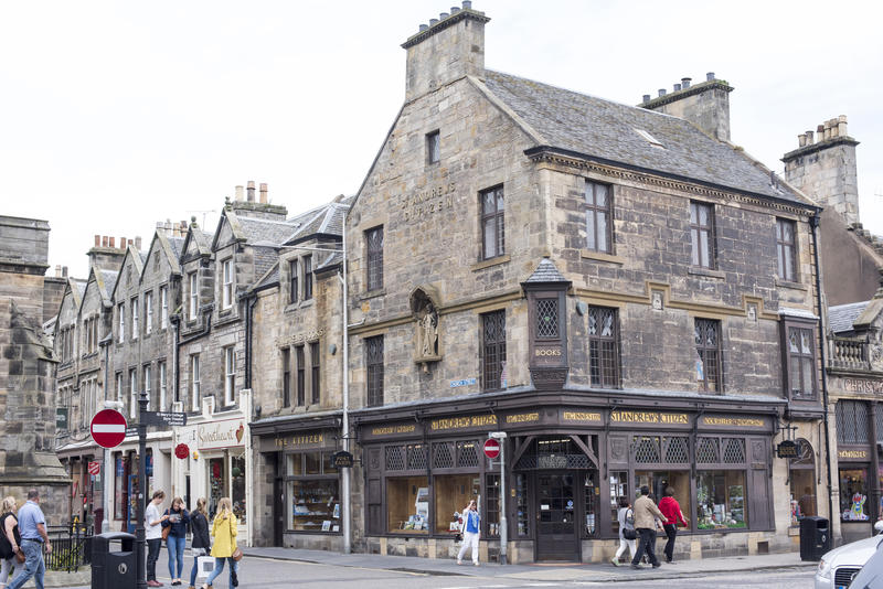Corner store and intersection used by various tourists walking around and shopping in Saint Andrews, Scotland