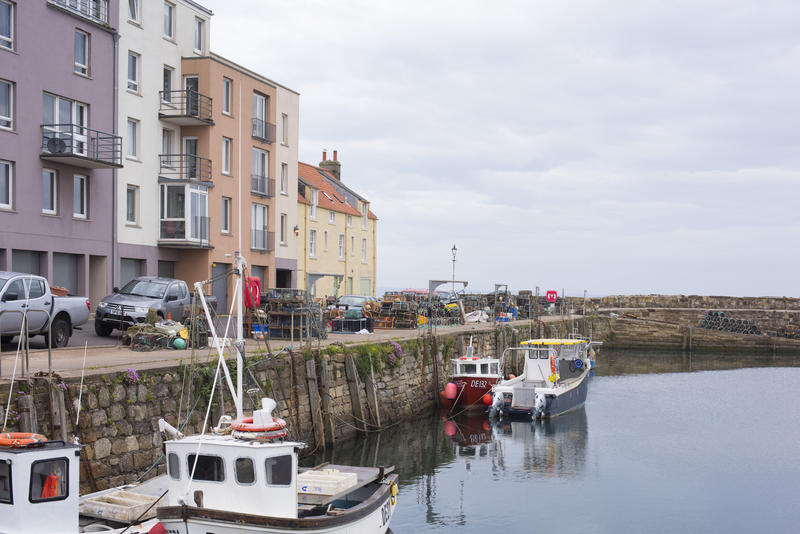 Fishing Boats Moored Alongside Stone Wall in Coastal Scotland on Overcast Day, St Andrews Fishing Harbor, Fife, Scotland