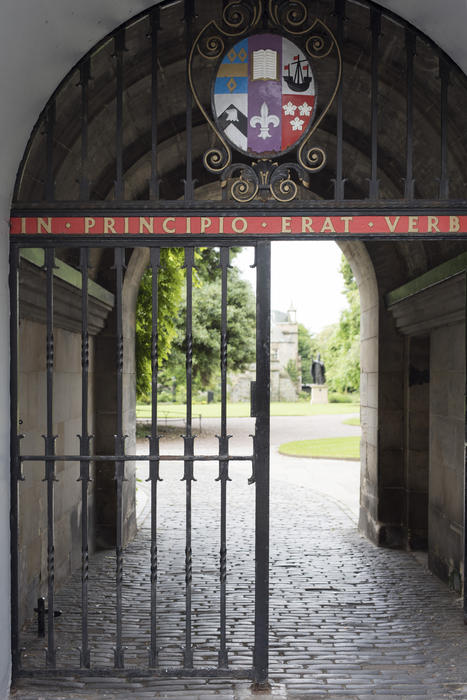 Entrance gate to St Andrews University, Scotland with the heraldic blazon and motto on the wrought ironwork