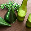 12100   Green ribbons and bottles of beer on table