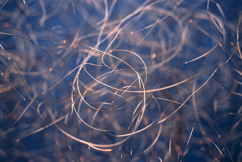 Tangled copper wires as full frame background for concepts about overuse or reliance on technology