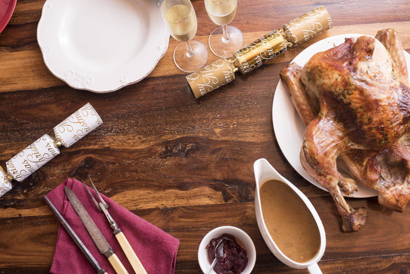 Flat lay view of thanksgiving dinner with roasted turkey on wooden table