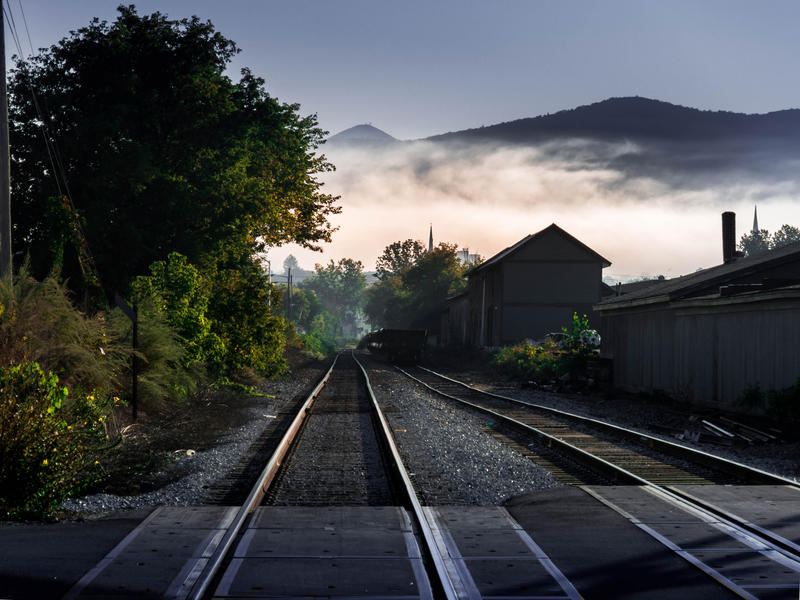 <p>Train tracks in the early morning with fog in rural Vermont.</p>