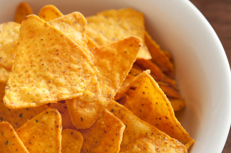 Bowl of delicious crunchy tortilla chips as seen from an overhead view