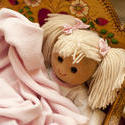 11979   Doll Nestled Under Blankets in Wooden Cradle