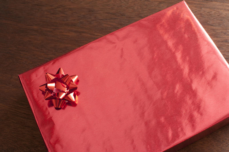 Red Valentines gift box with decorative bow and copy space on the gift wrap for your message to a sweetheart