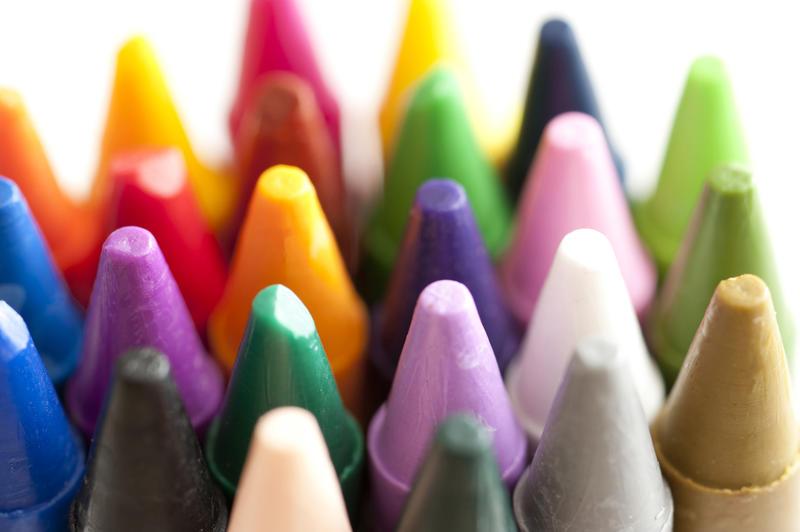 Close up of numerous colorful wax crayon tips or points in an art and creativity concept