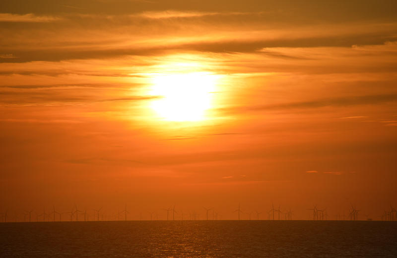 17037   A windfarm at sea with sunset