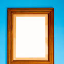 13114   Blank empty wooden frame on blue