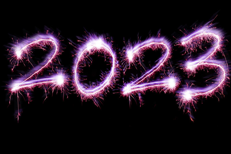 New Years 2023 sign with sparkling digits colored in for LGBTQ Pride celebration theme concpet, isolated on black background with copy space