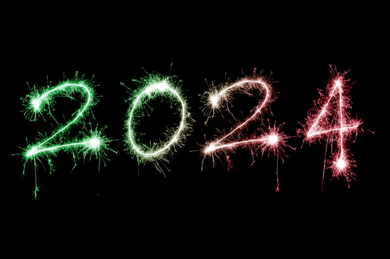 2024 red and green festive New Year sparkler background over black with copy space for your holiday greeting