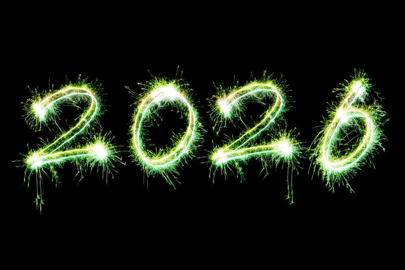 New Years 2026 digits drawn with bright sparkling lights isolated on black background