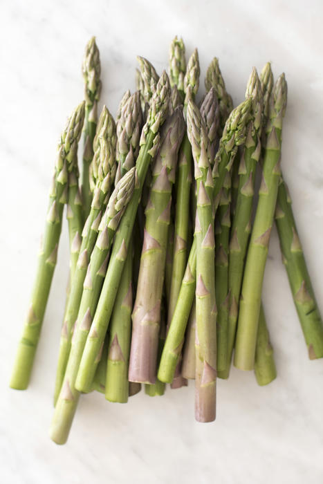 Bunch of raw fresh green asparagus spears, shoots or tips a delicious spring delicacy on a white background