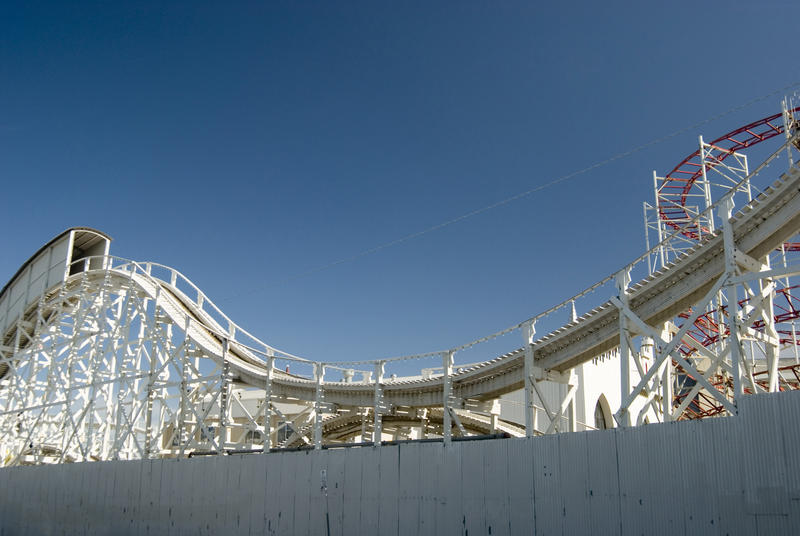 Undulating steel frame track of a Big Dipper rollercoaster at a fairground or amusement park looking towards a steeply inclined section