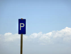 17821   Blue parking sign in front of a cloudy sky