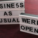 stock image 17401   Two signs outside a business or store