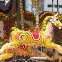 17799   Decorative brightly colored horse on a carousel