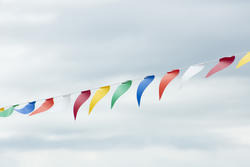 17871   String of colourful bunting against a cloudy sky