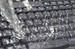 17863   Concept of IT waste with water soaking a keyboard