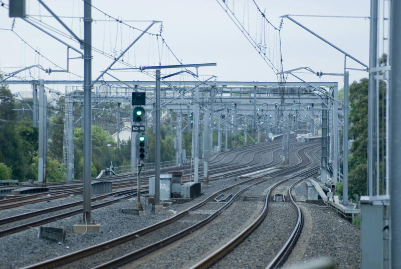 Empty railway lines with green signal winding away into the distance showing the effect of the travel ban during the Covid-19 pandemic