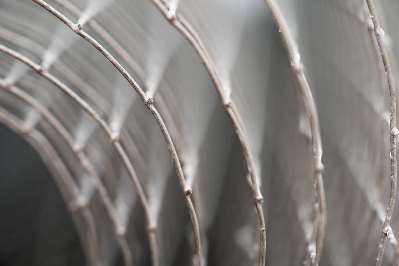 A close up angle of roll of fencing wire with shallow depth of field.