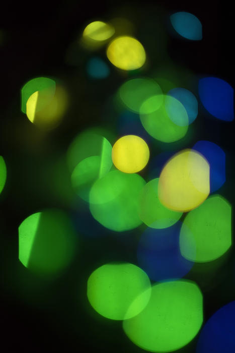 a background of overlapping green yellow and blue bokeh circles
