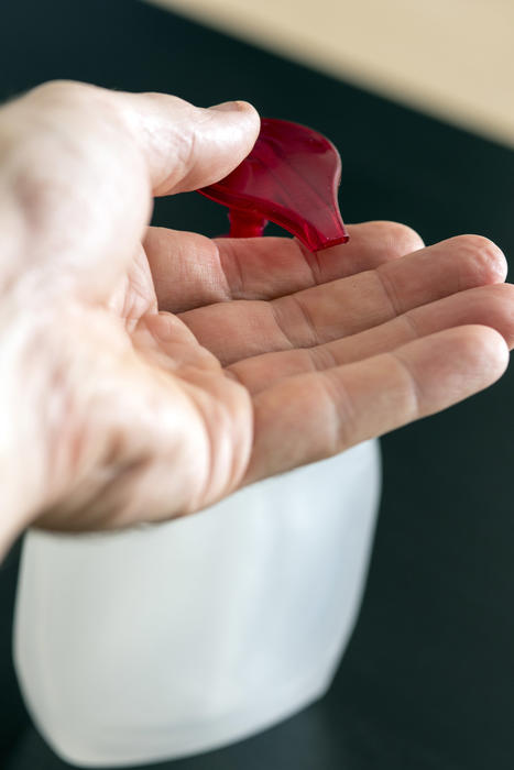 Man using hand soap or sanitizer or sanitiser to wash his hands during the Covid-19 pandemic in a concept of personal hygiene and infection control