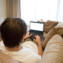 stock image 17402   Young businessman working from home an a laptop