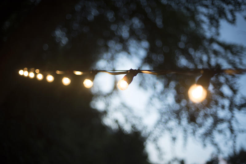 an outdoor festoon or string of white coloured lights