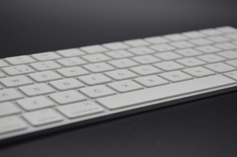 <p>Apple Mac keyboard with black background</p>
Apple Mac keyboard