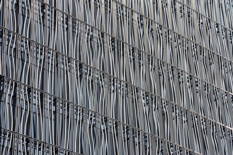 Wavy decorative metal facade on a modern building in an oblique full frame architectural background