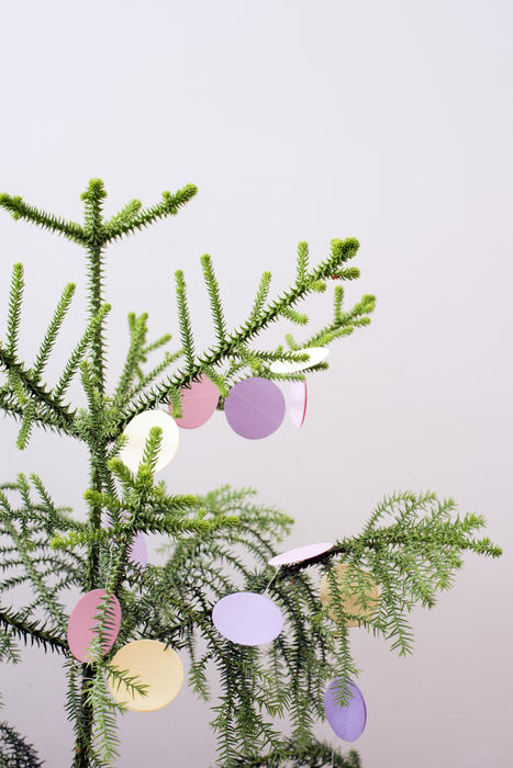 a tree decorated with pastel coloured paper decorations