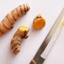 17255   Close up of turmeric and knife on chopping board