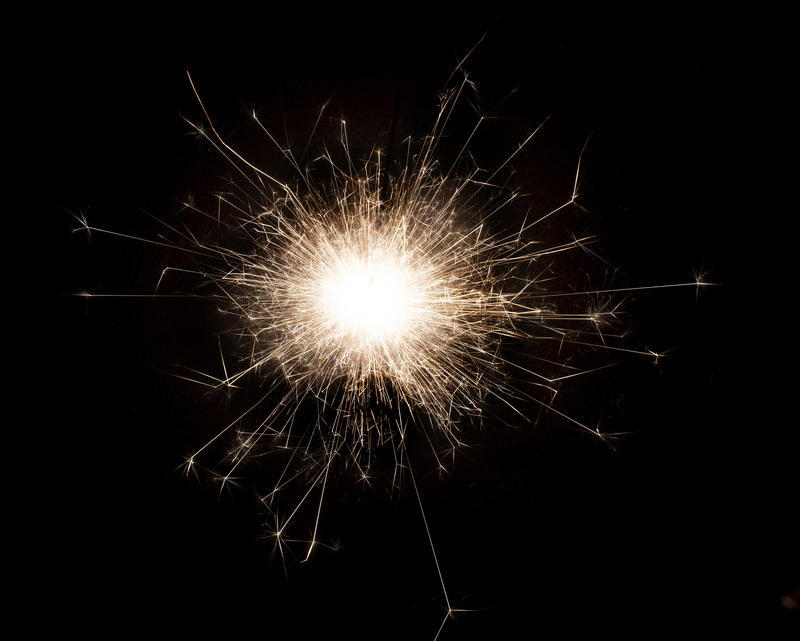 a vibrant point of light with an explosion of sparks being emitted