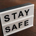 stock image 17412   Small Stay Safe sign on a table or floor