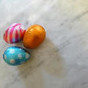 17367   Three chocolate eggs on marble surface