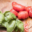 17268   Sliced tomato and fresh basil on a chopping board