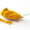 17270   Full spoon of turmeric spice in close up
